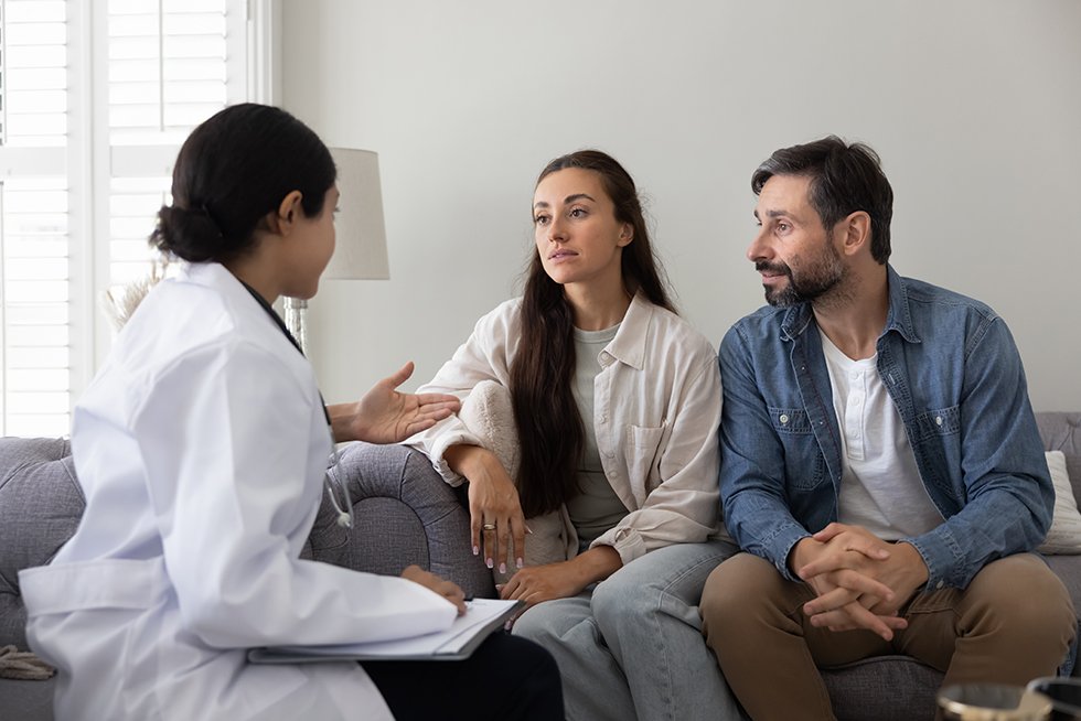 A fertility professional discussing care options with a couple